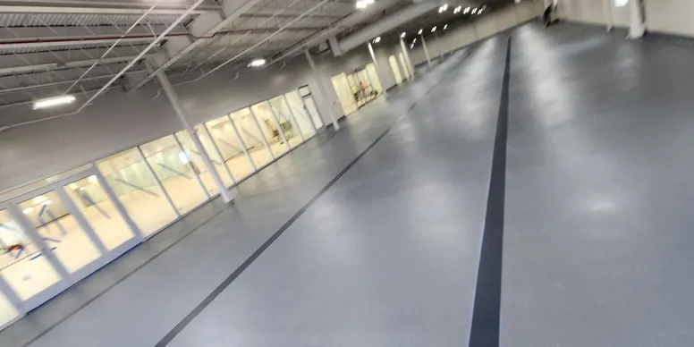 Industrial gray urethane cement floor in a large commercial facility