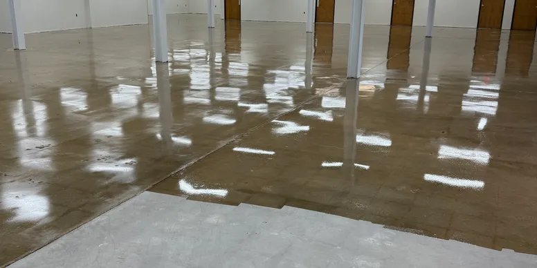 Sealed concrete warehouse floor with reflective satin finish