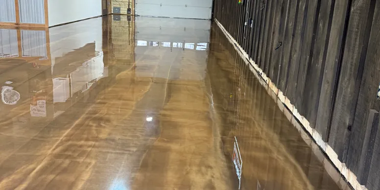 Metallic epoxy floor with rich amber and pearl swirls