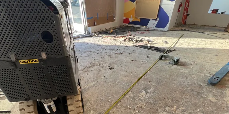 Shot blasting equipment profiling a concrete substrate during prep work